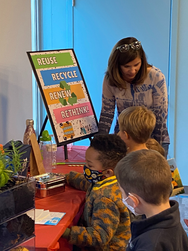 Presenter talks to children about environmental responsibility.