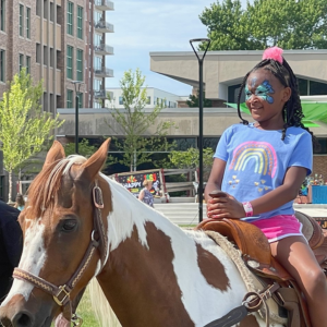 Child riding a horse at Centennial Commons